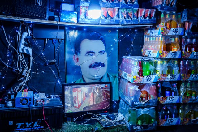<p>A picture of Abdullah Ocalan, the imprisoned leader of Turkey's banned Kurdistan Workers' Party, or PKK, is displayed inside a shop in the northern Syrian city of Qamishli</p>