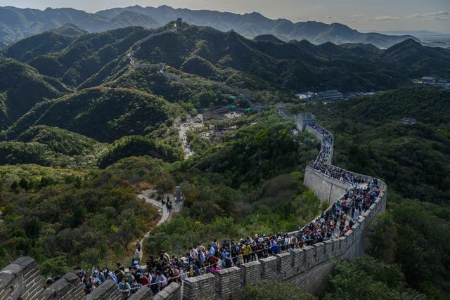 <p>Chinese tourists walk on a crowded section of the Great Wall</p>