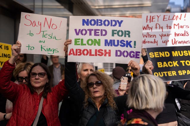 <p>Protesters outside a Tesla dealership on the weekend</p>