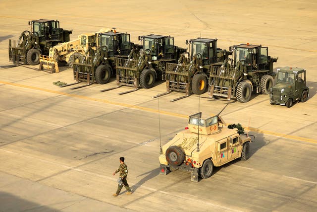 <p>File. An Afghan soldier passes an American military vehicle at the Bagram Air Base</p>